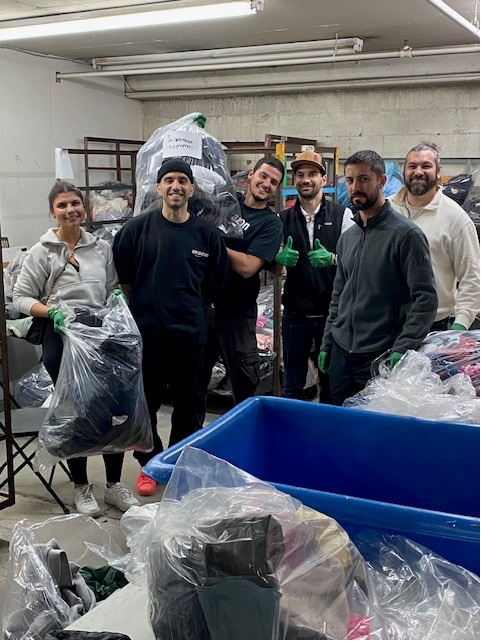 Amazon Canada employees giving a hand to sort winter items at the Le Support donation center